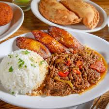 Versailles signature dishes Ropa ViejaLechon AsadoArroz Con PolloCuban Sandwich